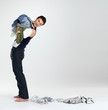 Happy young man carrying clothes in laundry