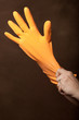 Photo: pulling on rubber dishwashing gloves pulling on rubber dishwashing gloves