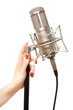 Woman's hand holding microphone stand