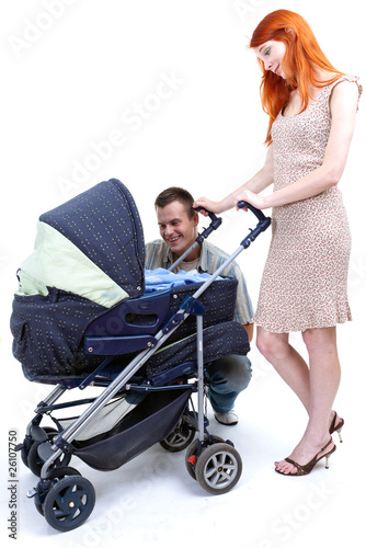 Photo: happy family - parents with baby stroller happy family - parents with baby stroller