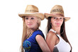 Two Girls Wearing cowboy Hats And Smiling Isolated On A White