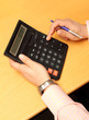 businessman counts money on calculator