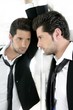 Handsome narcissistic young man looking in a mirror Handsome narcissistic young man looking in a mirror