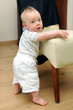 Cute boy learning to stand up