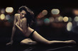Stunning brunette beauty posing over urban background