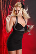 Cute blond in cocktail dress having a martini