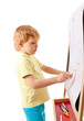 Four-year old boy drawing picture on easel