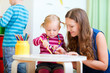 Mother drawing together with her daughter