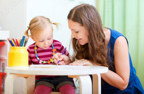 Photo: Mother and daughter drawing together Mother and daughter drawing together