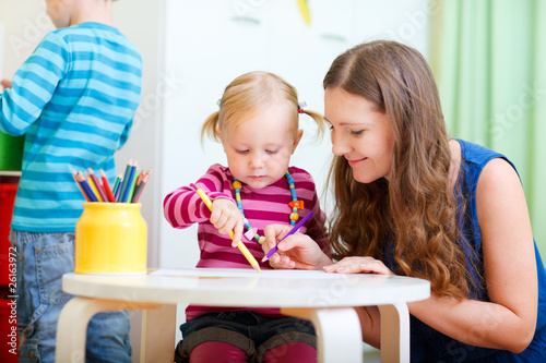 Photo: Mother drawing together with her daughter Mother drawing together with her daughter