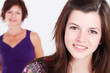 happy teen girl with mom in background