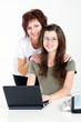 smart mom and daughter using laptop