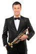 Young man in suit holding a trumpet