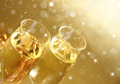Photo: Champagne glasses on golden background Champagne glasses on golden background