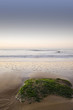 Beautiful view of beach at sunrise with rock details
