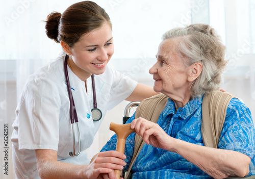 Photo: Senior woman is visited by her doctor or caregiver Senior woman is visited by her doctor or caregiver
