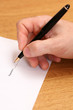 A close up of man's hand signing a contract