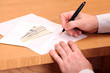 A businessman signing a contract and getting money for it A businessman signing a contract and getting money for it