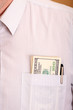 Close up of a shirt with one hundred dollar banknotes