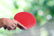 Arm with a table tennis racket outdoors Arm with a table tennis racket outdoors
