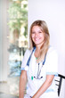 Photo: A pretty young woman nurse inside hospital building A pretty young woman nurse inside hospital building