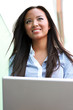 Woman on laptop outside in the city
