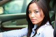 beautiful brunette asian businesswoman in a car