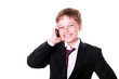 Photo: A small boy in suit on phone A small boy in suit on phone