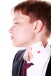 Photo: Young boy in a suit hides aces in his shirt Young boy in a suit hides aces in his shirt