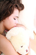 Beautiful woman sleeping with the toy bear