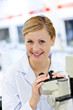 Delighted female scientist using a microscope Delighted female scientist using a microscope