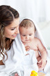Delighted mother drying her baby after his bath Delighted mother drying her baby after his bath