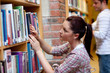 Pretty young woman looking for a book Pretty young woman looking for a book