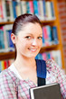 Joyful young caucasian woman holding a book Joyful young caucasian woman holding a book