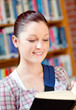 Positive young caucasian woman reading a book Positive young caucasian woman reading a book