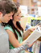 Beautiful couple of students reading a book Beautiful couple of students reading a book