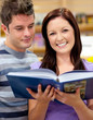 Bright couple of students reading a book Bright couple of students reading a book