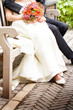 Photo: Closeup of bride and groom sitting in a park Closeup of bride and groom sitting in a park