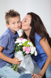 Little boy giving flowers to his mom on mother's day