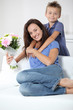 Little boy giving flowers to his mom on mother's day