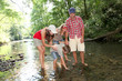 Family crossing a river