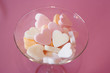 hearts in glass on pink background