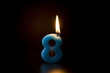 Number 8 candle on black background