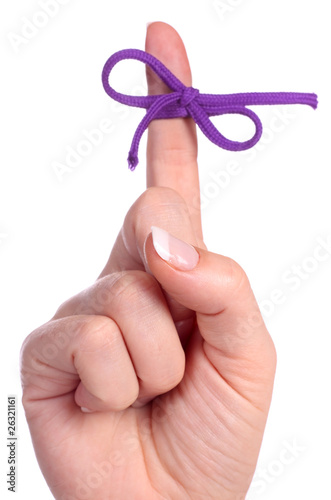 Photo: A finger contains a bow-tied string as a reminder A finger contains a bow-tied string as a reminder