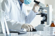 Foto: Scientist with microscope and computer Scientist with microscope and computer