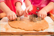 little girls cutting gingerbread christmas cookies, hands only little girls cutting gingerbread christmas cookies, hands only