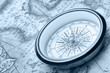 Old compass on ancient map