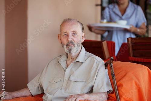 Photo: senior elderly man with carer serving meal senior elderly man with carer serving meal