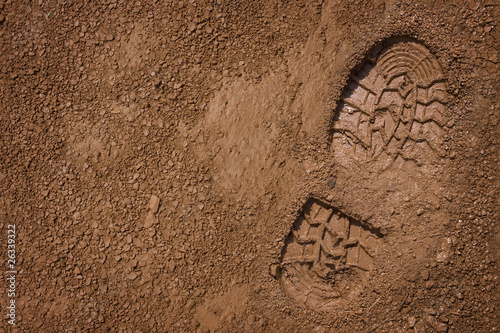 Photo: Footprint on mud with copy space Footprint on mud with copy space