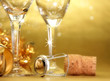 Champagne glasses on golden background